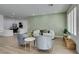Bright living room area featuring hardwood floors, three large windows, and modern decor at 10389 Felice Ave, Las Vegas, NV 89135