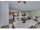 Stylish open-plan space blending dining and living areas with modern decor and kitchen featuring ample counter space at 10389 Felice Ave, Las Vegas, NV 89135