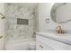Bathroom with tub-shower featuring marble tiling, marble countertop and gold fixtures at 10482 Clarion River Dr, Las Vegas, NV 89135