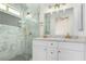 Bathroom featuring marble counter tops, dual sinks, a glass shower, and modern gold hardware at 10482 Clarion River Dr, Las Vegas, NV 89135