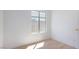 Bedroom featuring a window, neutral paint, base trim and light hardwood floors at 10482 Clarion River Dr, Las Vegas, NV 89135