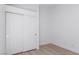 Bedroom featuring a closet with sliding doors, neutral paint and light hardwood floors at 10482 Clarion River Dr, Las Vegas, NV 89135