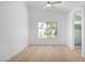 Bright bedroom features a ceiling fan, wood floors, and window overlooking the backyard at 10482 Clarion River Dr, Las Vegas, NV 89135