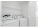 Bright laundry room featuring modern washer and dryer units and white walls at 10482 Clarion River Dr, Las Vegas, NV 89135
