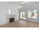 Features a stone fireplace, wood floors, large windows, and access to the backyard, creating a bright atmosphere at 10482 Clarion River Dr, Las Vegas, NV 89135
