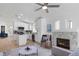 Staged open-concept living room with wood floors, a fireplace, and a modern kitchen, creating a stylish and functional space at 10482 Clarion River Dr, Las Vegas, NV 89135