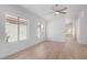 Bright living room with wood floors, light walls, and natural light from large windows, creating a modern and open space at 10482 Clarion River Dr, Las Vegas, NV 89135