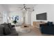 Staged living room with light wood floors, blue accents, a gray sofa, and modern décor for a cozy atmosphere at 10482 Clarion River Dr, Las Vegas, NV 89135