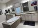 Bathroom showcasing a freestanding tub, double vanities, and granite countertops at 11318 San Arezzo Pl, Las Vegas, NV 89141