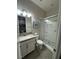 A well-lit bathroom includes a vanity, toilet, and glass-enclosed shower with modern fixtures at 11318 San Arezzo Pl, Las Vegas, NV 89141
