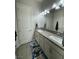 Bathroom featuring double sinks, white cabinets, and an eye-catching rug at 11318 San Arezzo Pl, Las Vegas, NV 89141
