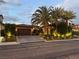 Beautiful front exterior with lush landscaping and a paver driveway creating curb appeal at 11318 San Arezzo Pl, Las Vegas, NV 89141