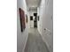 Hallway with wood look tile flooring and decorative art hanging on the wall at 11318 San Arezzo Pl, Las Vegas, NV 89141