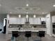 Modern kitchen with a large island, pendant lighting, and stainless steel appliances at 11318 San Arezzo Pl, Las Vegas, NV 89141