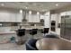 Well-lit kitchen with a large center island, pendant lights, and stainless steel appliances at 11318 San Arezzo Pl, Las Vegas, NV 89141