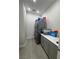 This organized laundry room features modern stacked appliances, cabinets and bright lighting at 11318 San Arezzo Pl, Las Vegas, NV 89141