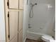 Clean bathroom featuring a shower over tub and a built-in storage cabinet at 1150 N Buffalo Dr # 2093, Las Vegas, NV 89128