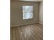 Bright bedroom featuring wood-look flooring and a window with blinds for natural light at 1150 N Buffalo Dr # 2093, Las Vegas, NV 89128