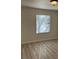 Well-lit bedroom featuring a large window and wood-look flooring at 1150 N Buffalo Dr # 2093, Las Vegas, NV 89128