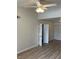 Bedroom with light colored walls, wood-look flooring, and ceiling fan at 1150 N Buffalo Dr # 2093, Las Vegas, NV 89128