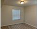 Cozy bedroom featuring wood-look flooring and a window with bright natural light at 1150 N Buffalo Dr # 2093, Las Vegas, NV 89128
