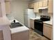 Clean kitchen featuring modern appliances, white countertops, and wooden cabinetry at 1150 N Buffalo Dr # 2093, Las Vegas, NV 89128