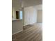 Open-concept living area with wood-look floors and a seamless transition to tile at 1150 N Buffalo Dr # 2093, Las Vegas, NV 89128