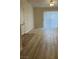 Bright living area with ceiling fan, sliding glass door, and wood-look floors at 1150 N Buffalo Dr # 2093, Las Vegas, NV 89128