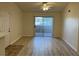 Bright living room with wood-look flooring and sliding glass doors to outdoor space at 1150 N Buffalo Dr # 2093, Las Vegas, NV 89128
