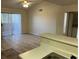 Open living space with wood-look flooring with kitchenette, leading to patio at 1150 N Buffalo Dr # 2093, Las Vegas, NV 89128