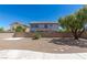 Large backyard space with rock landscaping, patio, and mature trees at 11698 Firesteed Pl, Las Vegas, NV 89141