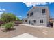 Backyard featuring a stone patio, a lush green tree and rock landscaping all around at 11698 Firesteed Pl, Las Vegas, NV 89141