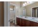 Well-lit bathroom with double sink vanity and separate toilet and shower area at 11698 Firesteed Pl, Las Vegas, NV 89141