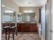 Bright bathroom with dual sinks, granite counters, warm cabinets, and a separate shower and bathtub at 11698 Firesteed Pl, Las Vegas, NV 89141