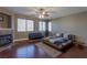 Spacious bedroom featuring a fireplace, ceiling fan, and dark hardwood flooring throughout at 11698 Firesteed Pl, Las Vegas, NV 89141