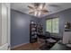 Comfortable bedroom featuring wood flooring, built-in desk, and a ceiling fan at 11698 Firesteed Pl, Las Vegas, NV 89141
