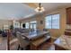 Inviting dining area featuring a wooden table with bench seating and an open view to the living room at 11698 Firesteed Pl, Las Vegas, NV 89141