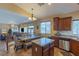 Open concept kitchen with stainless appliances, granite countertops, adjacent to living and dining areas at 11698 Firesteed Pl, Las Vegas, NV 89141