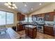 Well-equipped kitchen with stainless steel appliances, granite countertops, custom cabinets and center island at 11698 Firesteed Pl, Las Vegas, NV 89141