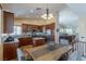 Bright kitchen with stainless steel appliances, a center island, and an adjacent dining area at 11698 Firesteed Pl, Las Vegas, NV 89141