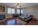 Spacious bedroom with fireplace, ceiling fan, and large windows providing plenty of natural light at 11698 Firesteed Pl, Las Vegas, NV 89141