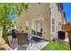 Backyard patio with artificial turf, a sliding glass door, and modern seating at 11919 Jersey Lilly St, Las Vegas, NV 89183