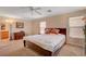 Comfortable bedroom with a ceiling fan, two windows, and a matching dark-wood bedroom set at 11919 Jersey Lilly St, Las Vegas, NV 89183