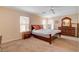 Bedroom with neutral walls, carpet, ceiling fan, and a dark wood furniture set at 11919 Jersey Lilly St, Las Vegas, NV 89183