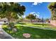 Beautifully landscaped community park with lush green grass, trees, benches, and sidewalks at 11919 Jersey Lilly St, Las Vegas, NV 89183
