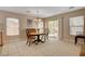 Cozy dining area with wood table, chandelier lighting, and sliding glass doors to the patio at 11919 Jersey Lilly St, Las Vegas, NV 89183
