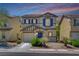 Charming two-story home with blue shutters, a well-manicured lawn, and a two-car garage at 11919 Jersey Lilly St, Las Vegas, NV 89183