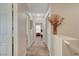 Carpeted upstairs hallway with adjacent bedrooms and bathroom, enhanced by a decorative floral arrangement at 11919 Jersey Lilly St, Las Vegas, NV 89183