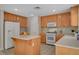 Bright kitchen with white appliances, tile backsplash, and a functional center island at 11919 Jersey Lilly St, Las Vegas, NV 89183