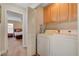 Convenient laundry room with washer, dryer, and overhead storage cabinets at 11919 Jersey Lilly St, Las Vegas, NV 89183